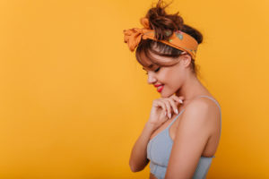 Young woman with an orange bandanna in her hair.